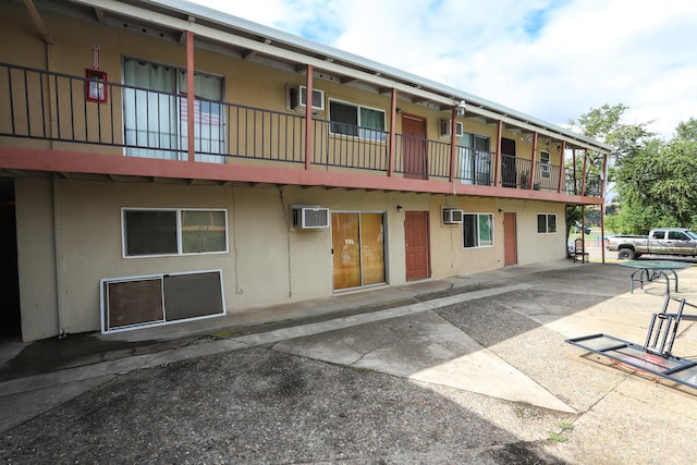 view of building exterior featuring a wall mounted air conditioner