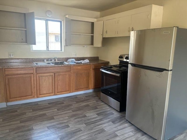 kitchen with light hardwood / wood-style flooring, stainless steel appliances, and sink