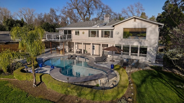 rear view of property with a patio and a yard