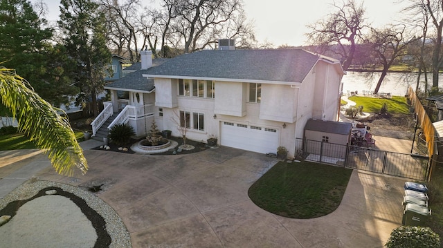 view of front facade with a water view and a garage