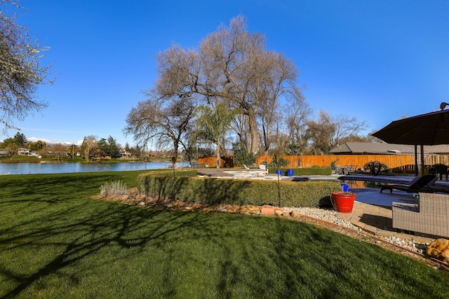 view of yard featuring a water view and a patio area