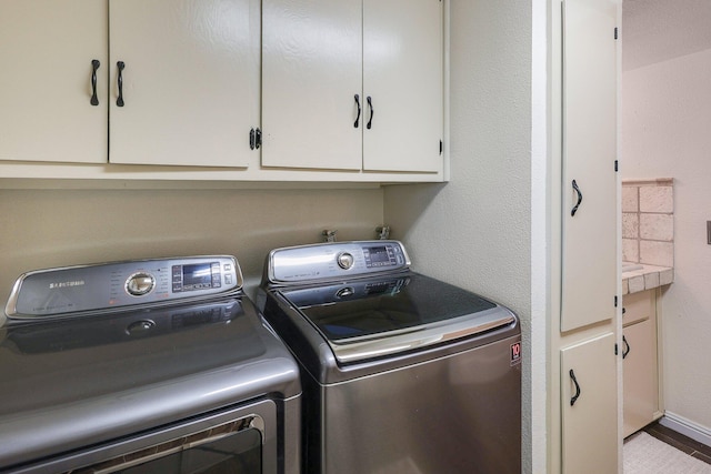 laundry room with cabinets and separate washer and dryer