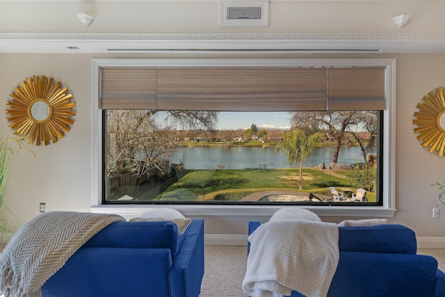 living area featuring carpet flooring and a water view