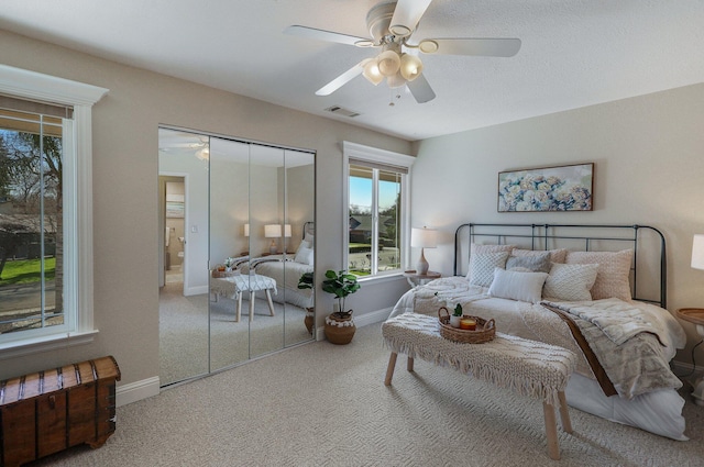 bedroom with ceiling fan, a closet, and carpet