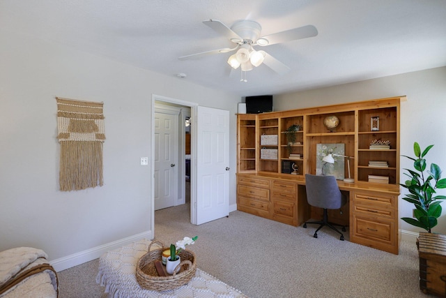 carpeted office space with ceiling fan