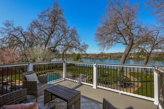 wooden terrace featuring a water view