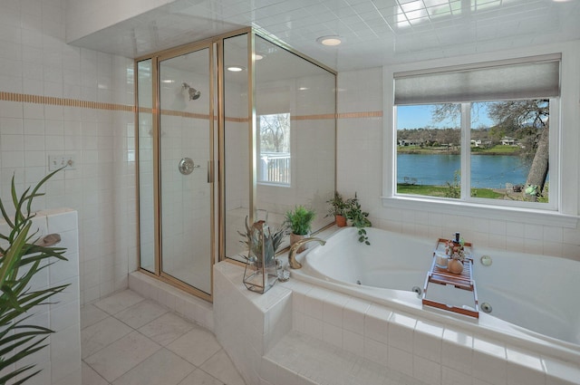 bathroom with tile patterned flooring, shower with separate bathtub, and a water view