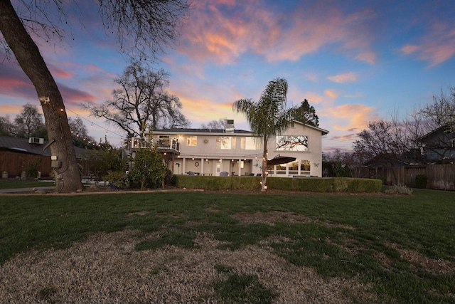 back house at dusk with a yard