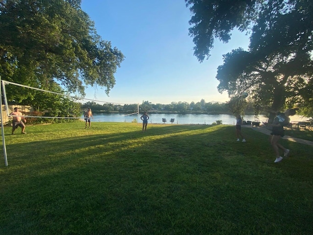 view of yard with a water view and volleyball court