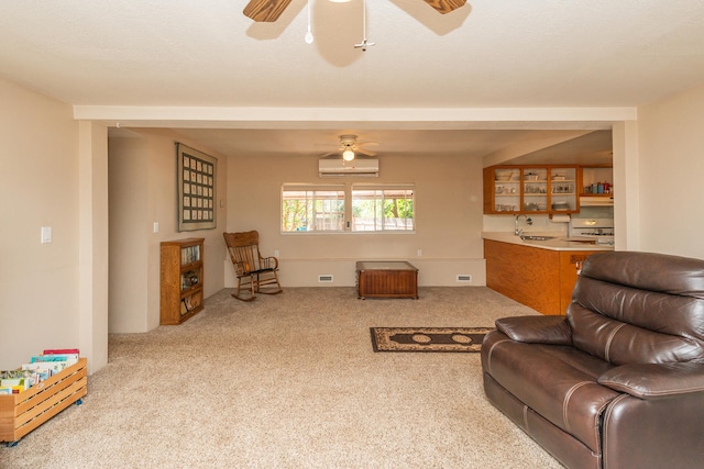 carpeted living room featuring ceiling fan, sink, and a wall unit AC