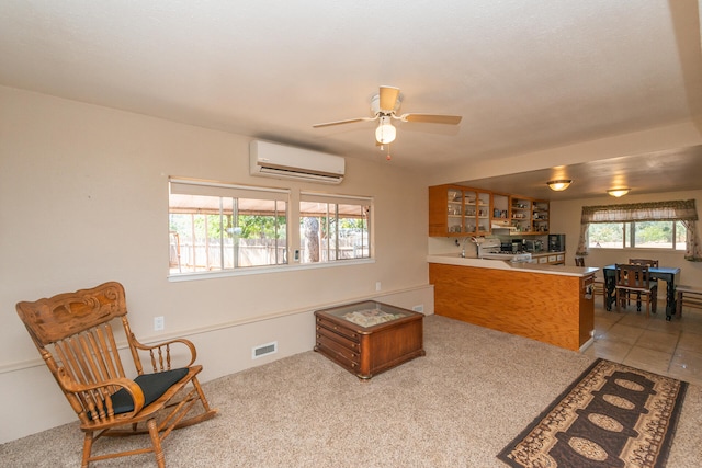 living room with light carpet, ceiling fan, plenty of natural light, and a wall mounted AC