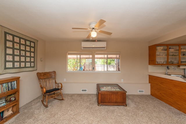 sitting room featuring light carpet, a wall unit AC, ceiling fan, and sink