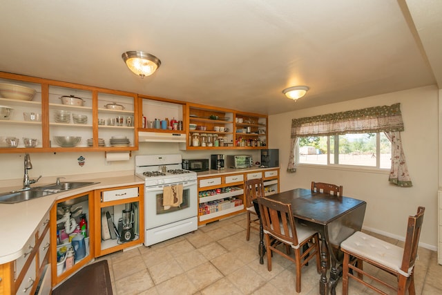 kitchen featuring sink and white gas range oven