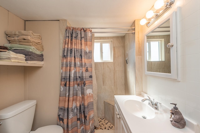 bathroom featuring a shower with curtain, vanity, toilet, and a healthy amount of sunlight