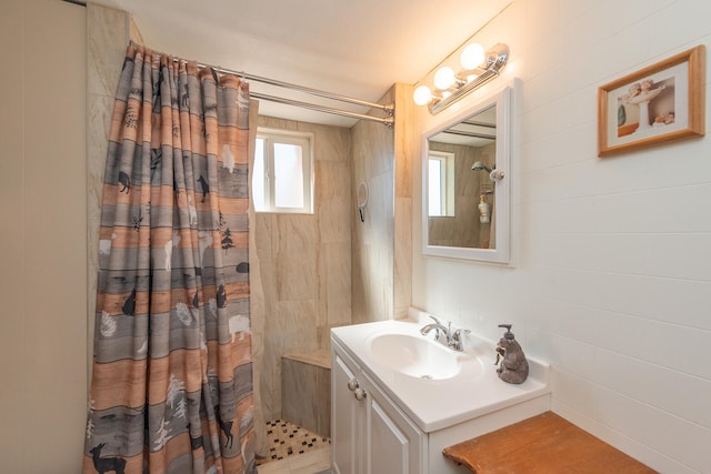 bathroom with vanity, tile walls, and curtained shower