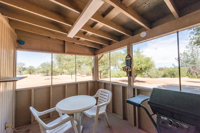 sunroom / solarium featuring vaulted ceiling