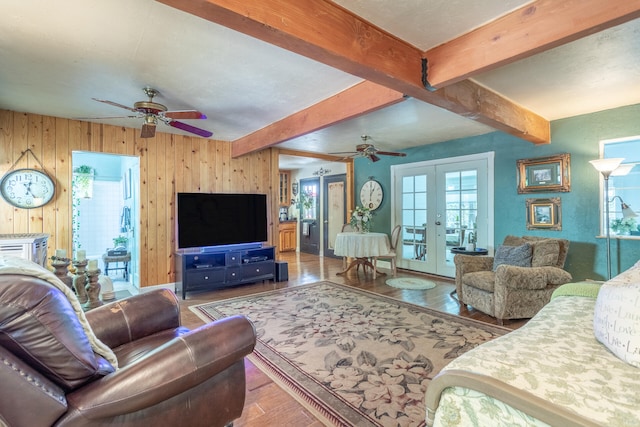 living room with beam ceiling, ceiling fan, french doors, and hardwood / wood-style flooring