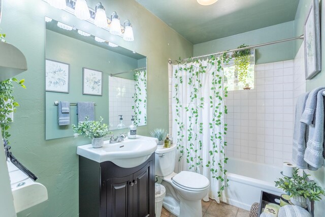 full bathroom featuring vanity, shower / bath combo with shower curtain, toilet, and tile patterned floors