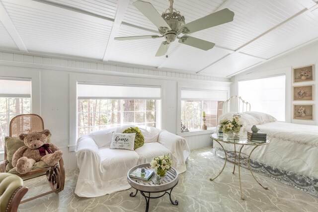 bedroom featuring carpet, lofted ceiling, ceiling fan, and wood walls