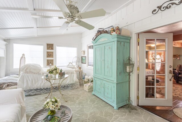 bedroom with lofted ceiling with beams, ceiling fan, and light hardwood / wood-style flooring