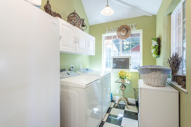 laundry area with washing machine and clothes dryer and cabinets