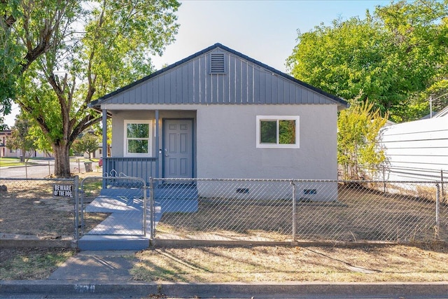 view of front of home featuring a fenced front yard and a gate