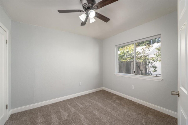 unfurnished room featuring carpet, baseboards, and a ceiling fan