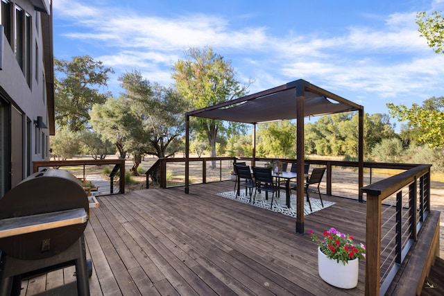 wooden terrace featuring grilling area and outdoor dining space