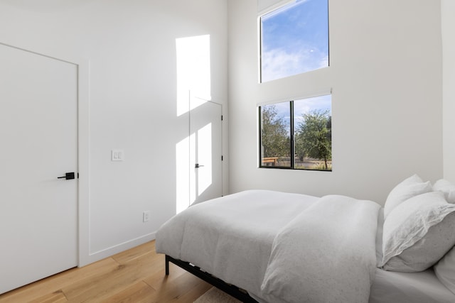 bedroom with baseboards and light wood finished floors