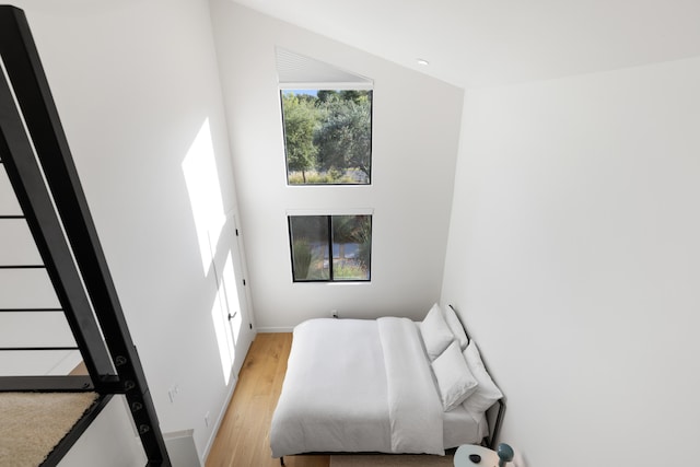 bedroom featuring light wood-style floors and baseboards