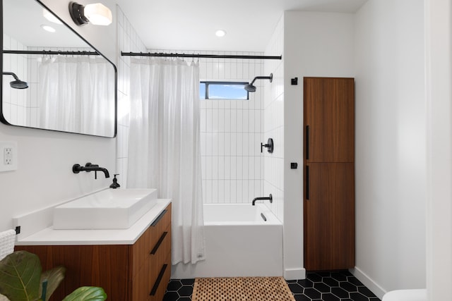 full bathroom with tile patterned floors, shower / bath combo, baseboards, and vanity