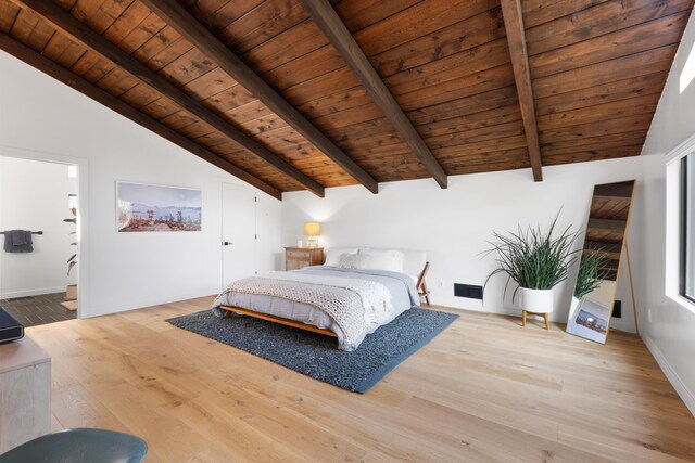 bedroom featuring wooden ceiling, vaulted ceiling with beams, baseboards, and wood finished floors