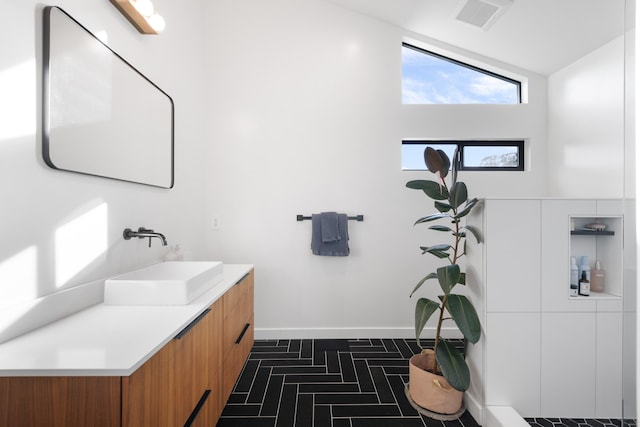 bathroom featuring vanity, visible vents, and baseboards