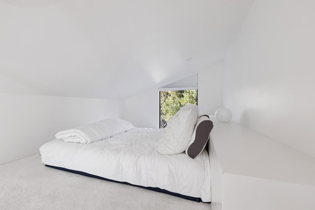 bedroom featuring carpet flooring and vaulted ceiling