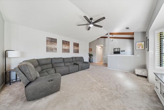 living room featuring ceiling fan, light colored carpet, and lofted ceiling