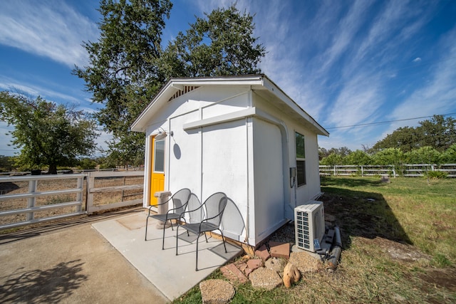 view of outbuilding featuring a yard and ac unit