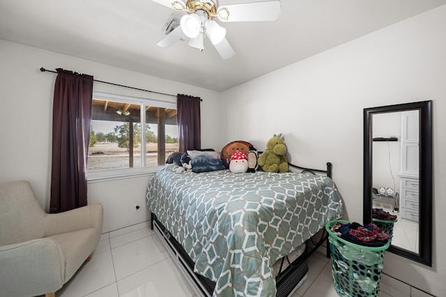 bedroom with ceiling fan and light tile patterned floors