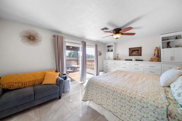 bedroom featuring access to outside, a textured ceiling, light tile patterned floors, and ceiling fan