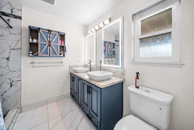 bathroom featuring vanity, toilet, and tiled shower