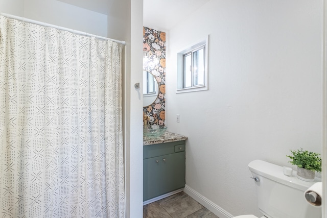 bathroom with tile patterned flooring, vanity, and toilet