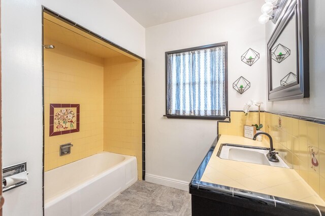 bathroom with vanity,  shower combination, and decorative backsplash