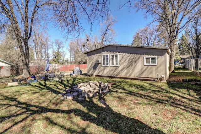 exterior space with fence and a yard