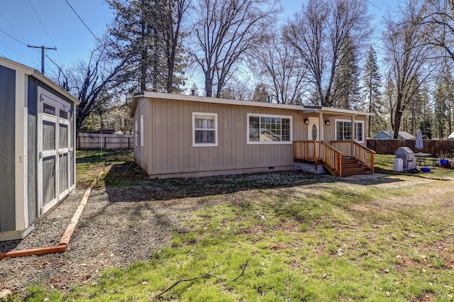 view of front facade with fence and crawl space