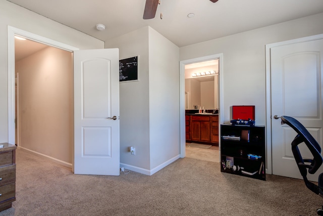 carpeted office featuring ceiling fan