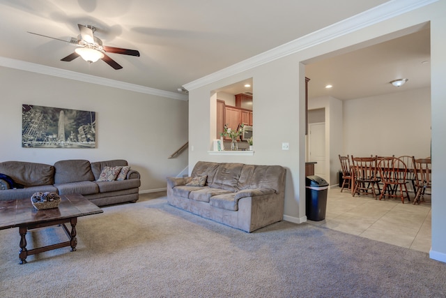 living room with ceiling fan, crown molding, and light carpet