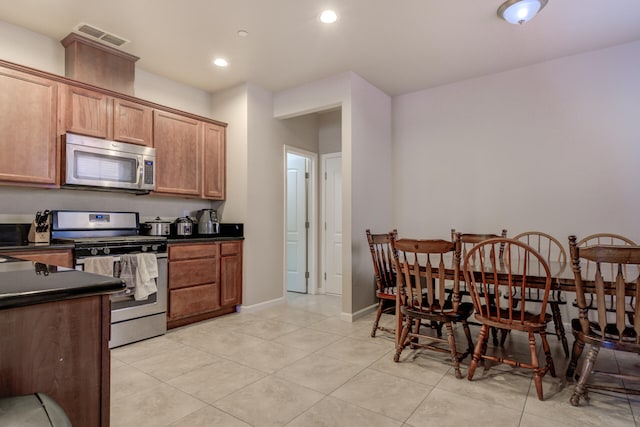 kitchen featuring appliances with stainless steel finishes and light tile patterned floors