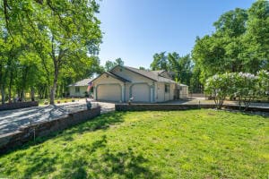 view of home's exterior with a lawn and a garage