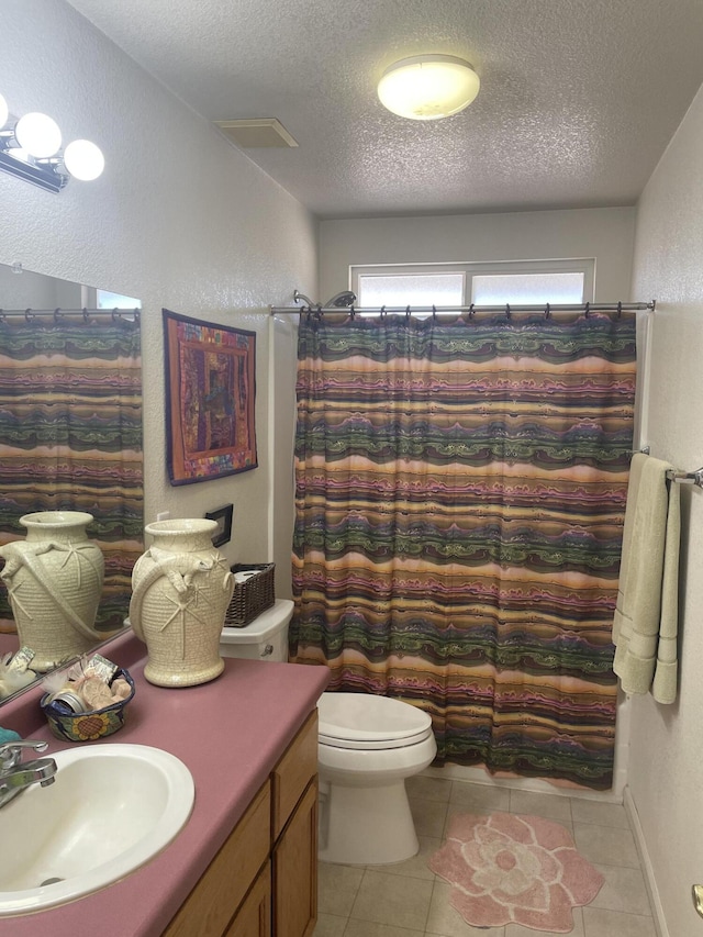 3471 Charles St, Cottonwood, CA 96022 - full bath featuring toilet, vanity, a textured ceiling, tile patterned flooring, and a textured wall