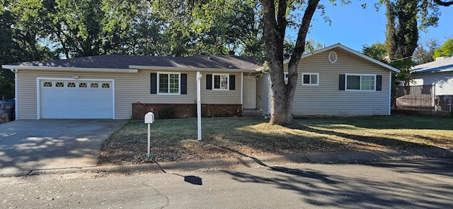 ranch-style house featuring a garage and a front yard