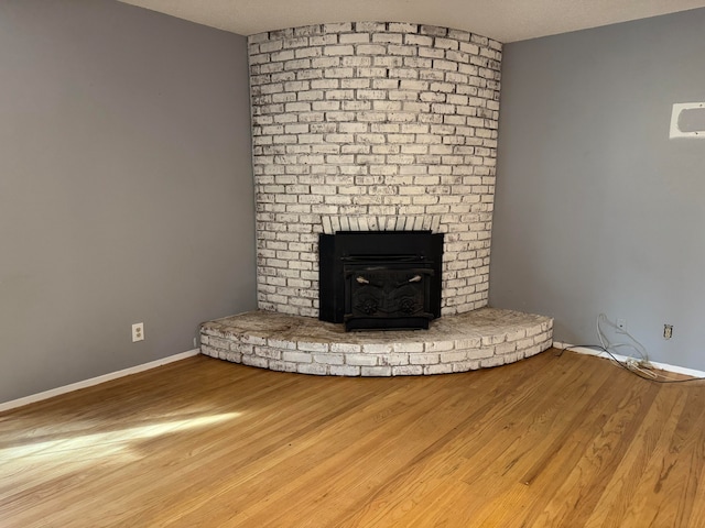 unfurnished living room featuring hardwood / wood-style floors and a textured ceiling